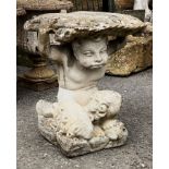 A small composite stone garden table or plinth - in the form of a figure of a boy supporting a