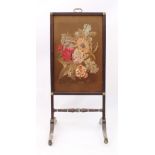 A mid-19th century faux-rosewood fire screen - with moulded frame, gilt-brass top handle and rosette