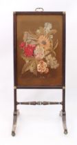 A mid-19th century faux-rosewood fire screen - with moulded frame, gilt-brass top handle and rosette