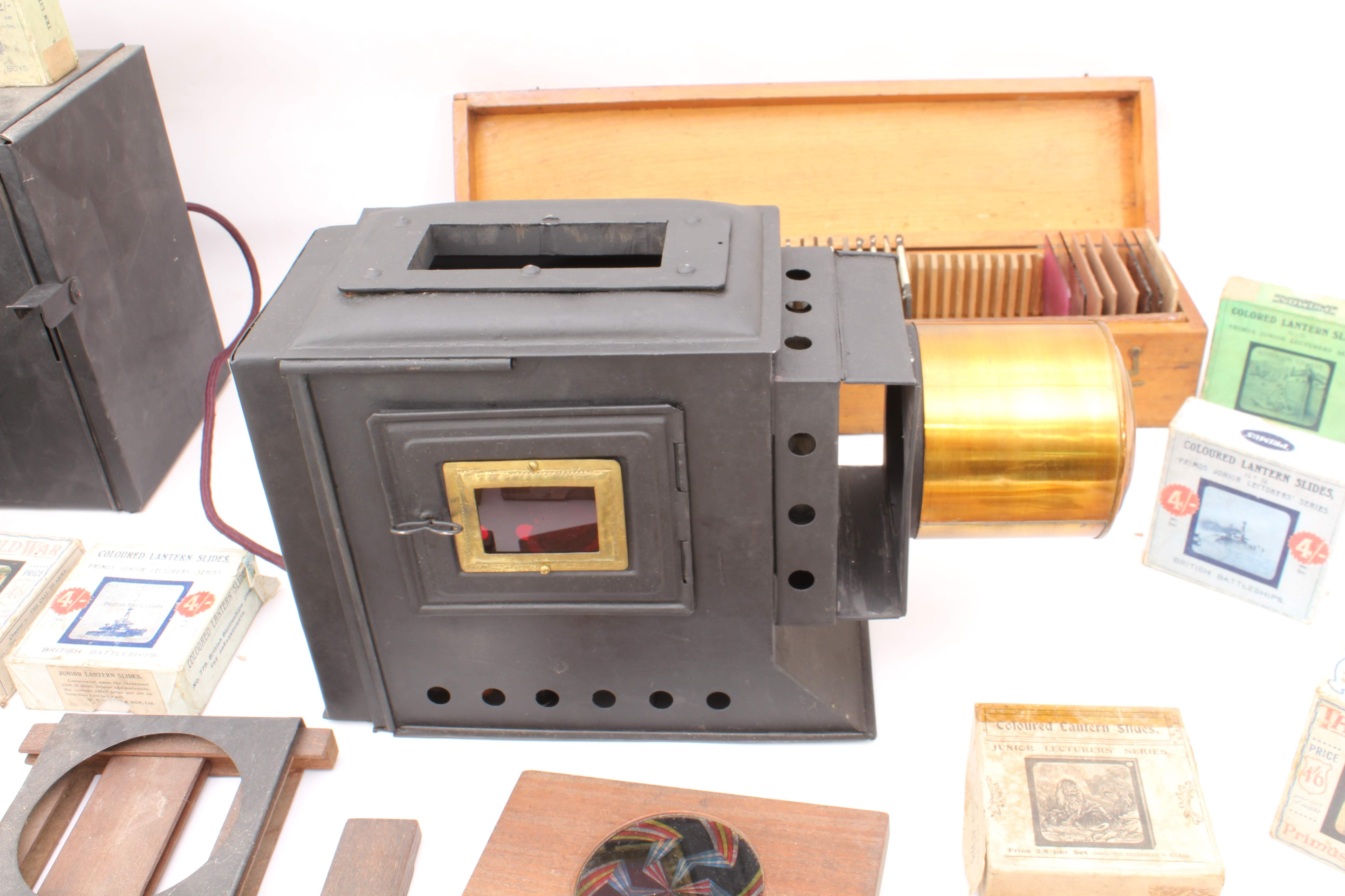 A cased magic lantern and a good quantity of slides to include: a mahogany and gilt-brass hand- - Image 12 of 14