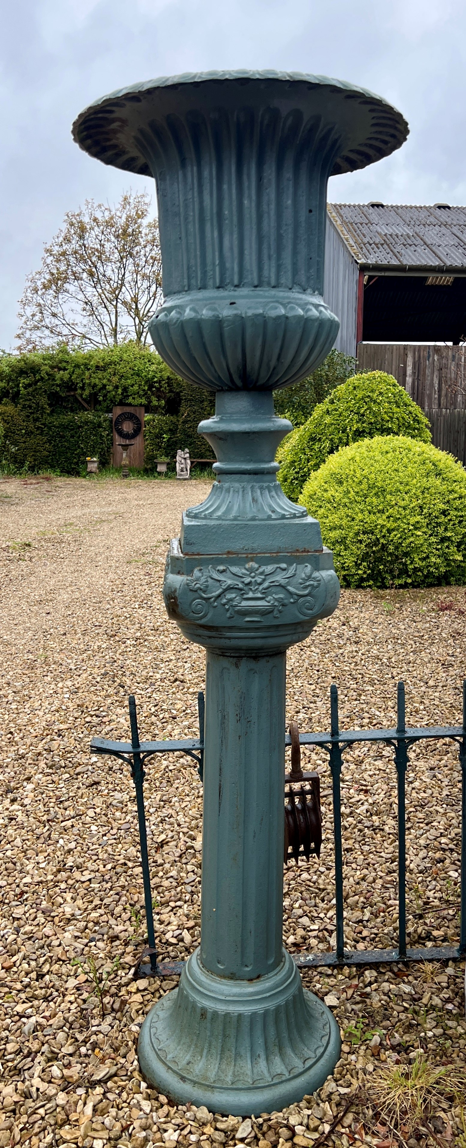 A pair of cast iron urns on column pedestals - painted dark green, the urns 57cm diameter, 72cm - Image 2 of 4