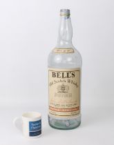 An oversized 4.5 litre Bells Extra Special Old Scotch Whiskey bottle - empty, no cap, some fading to