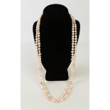 A long single-strand freshwater pearl necklace - with baroque-style pearls of varying pink and ivory