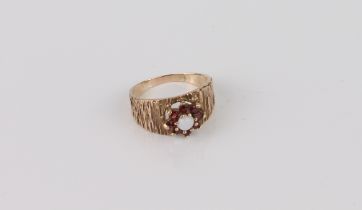 A vintage 9ct gold, white opal and garnet cluster ring - stamped '9CT', with bark effect