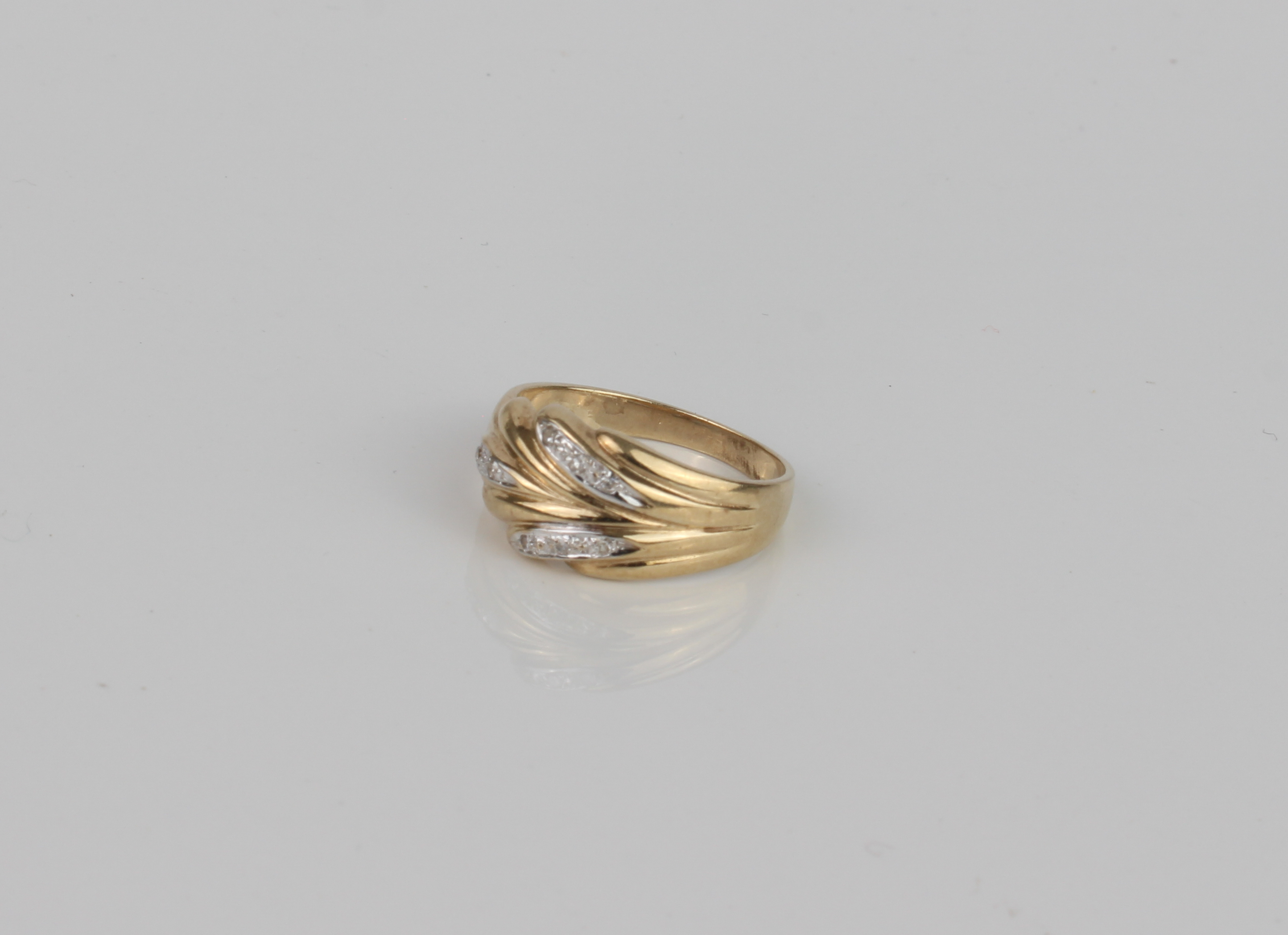 A 9ct gold and diamond ring - hallmarked Sheffield 1994, the foliate two-colour setting accented