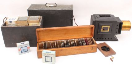 A cased magic lantern and a good quantity of slides to include: a mahogany and gilt-brass hand-