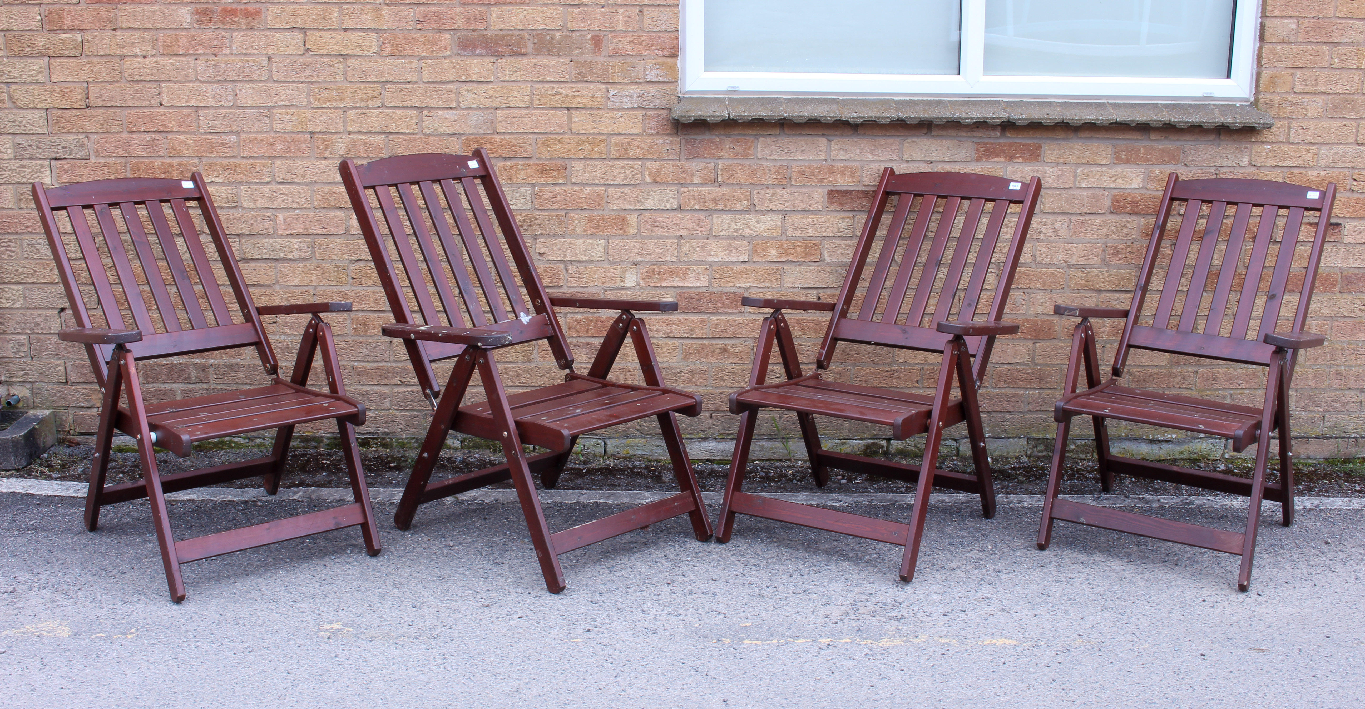 A set of four stained pine folding garden chairs - the seat backs adjustable to five positions, 66
