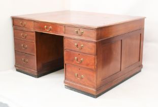 A mid-century mahogany partners' desk - the top with three frieze drawers to either side and an