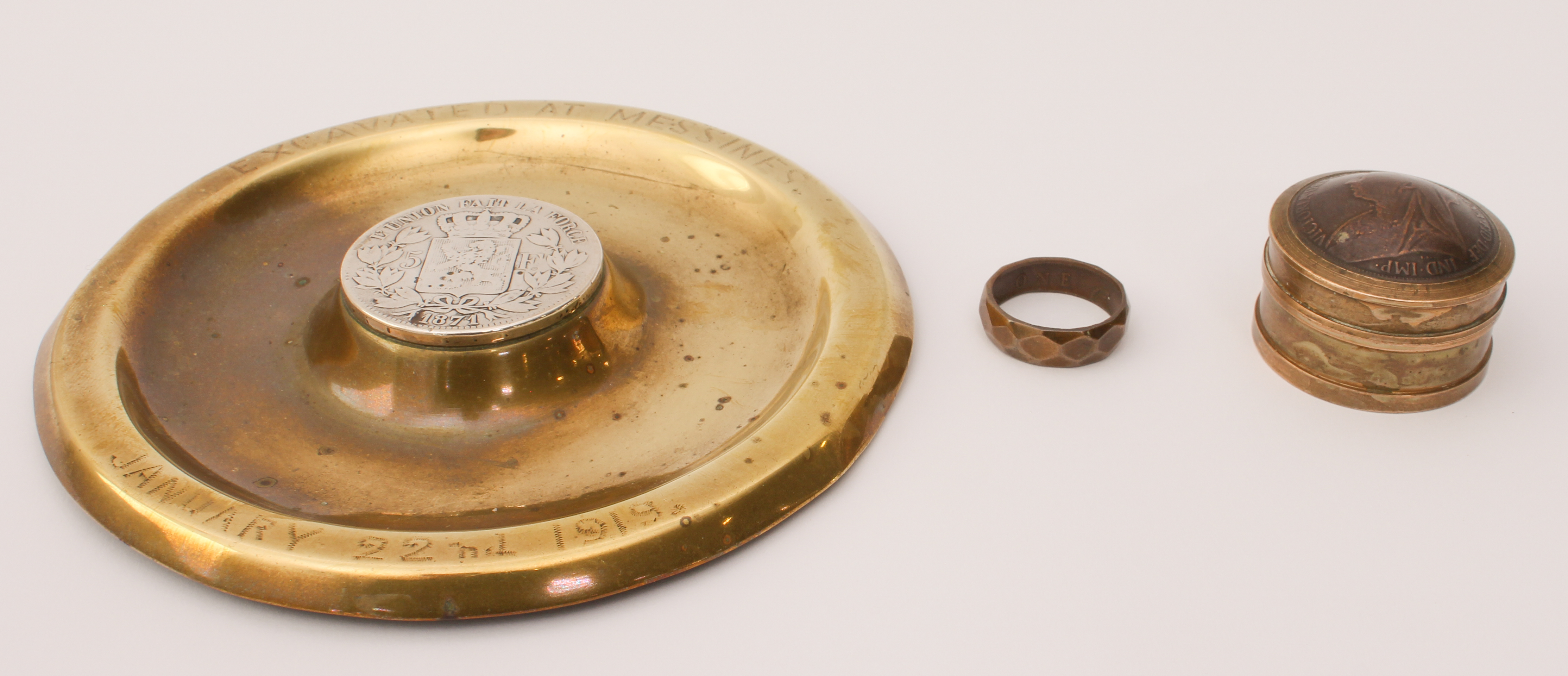 A WW1 trench art shell-case ashtray - inscribed 'Excavated at Messines. January 22nd 1919', with