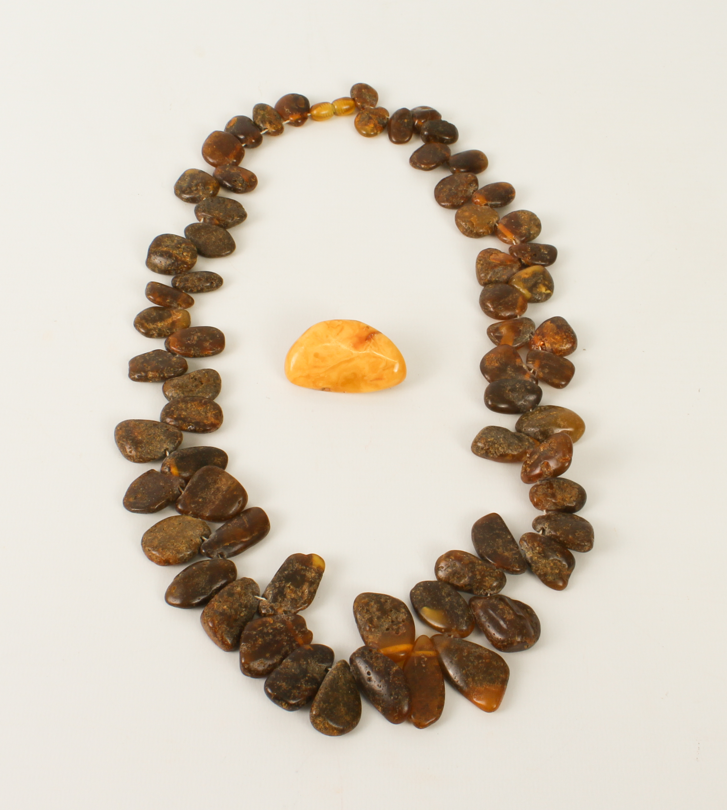 A Baltic amber necklace - with graduated, tumble polished beads and screw clasp, 57 cm long;
