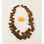 A Baltic amber necklace - with graduated, tumble polished beads and screw clasp, 57 cm long;