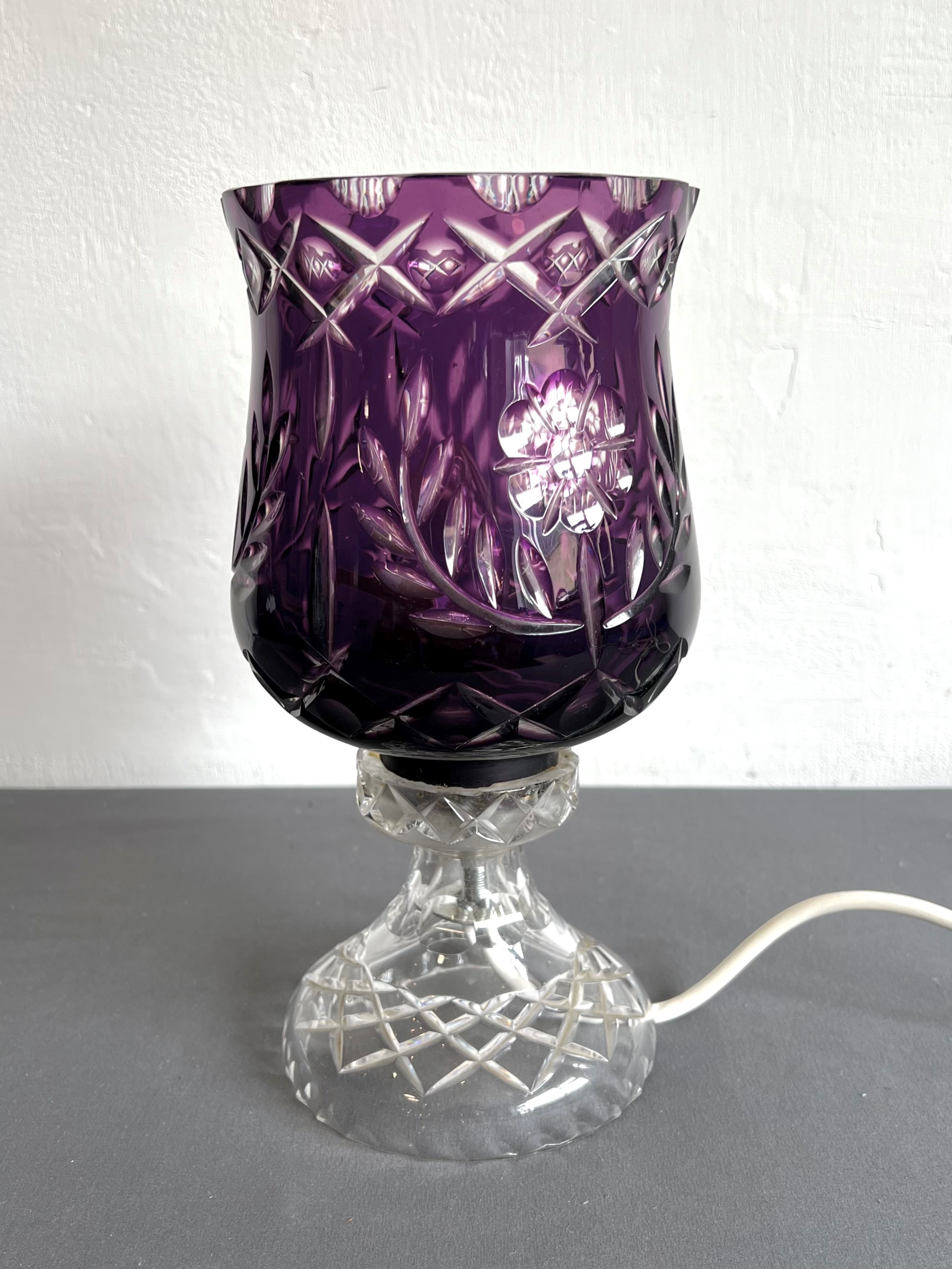 An amethyst cased glass table-lamp, possibly Scottish - the tulip-shaped shade with floral, diamond,