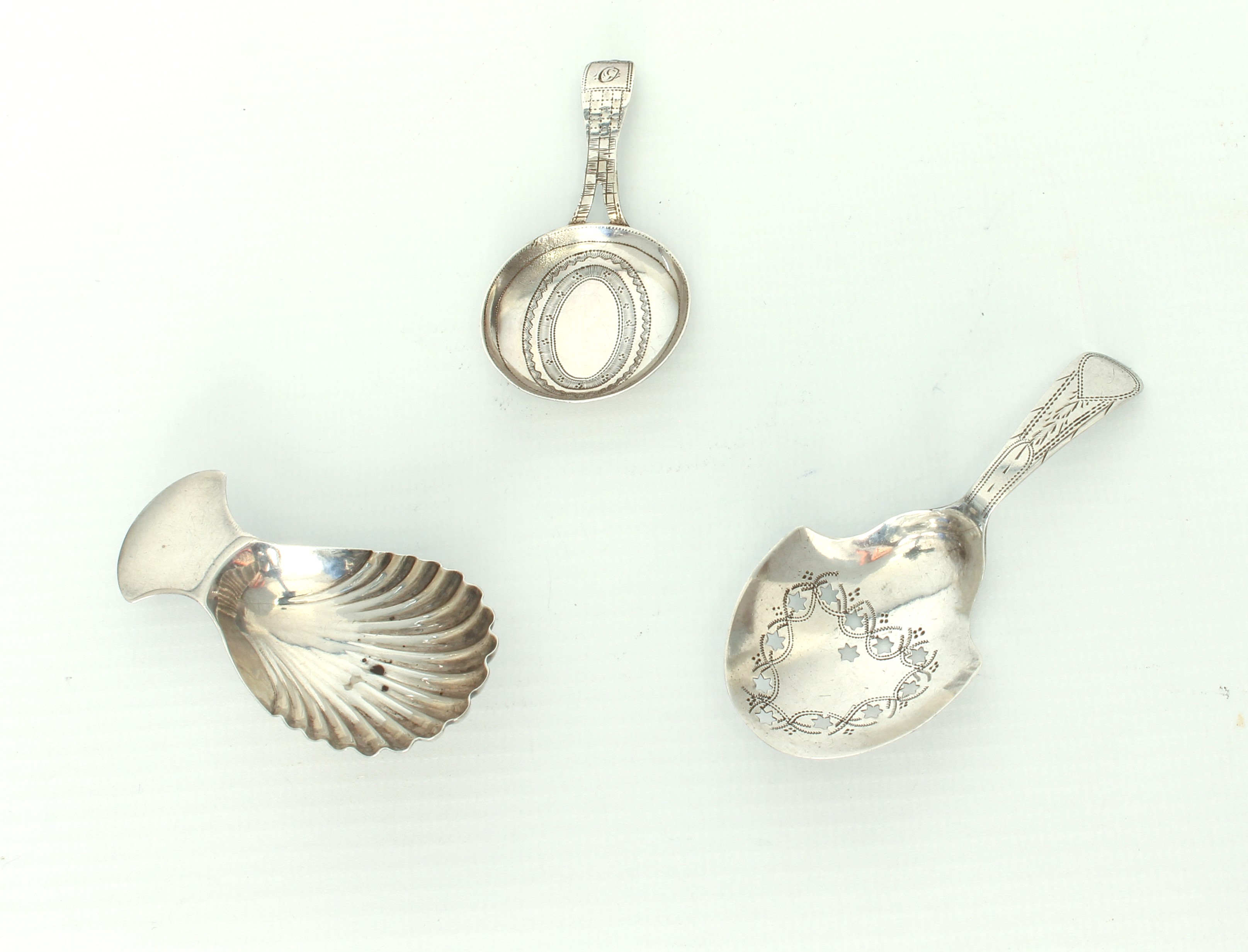 Three hallmarked silver George III caddy spoons. * Condition: The circular bowl spoon by William