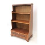 A reproduction 19th century style mahogany waterfall bookcase - the top with pierced brass