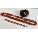 A silver and amber bracelet - with seven oval cabochon amber stones within pierced lattice