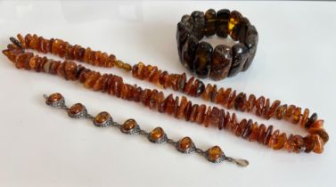 A silver and amber bracelet - with seven oval cabochon amber stones within pierced lattice