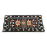 A 1920s-30s Chinese wool rug - decorated with vases and precious objects on a Royal blue ground,