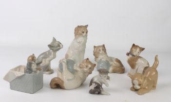 Seven porcelain figures of cats and Kittens by Lladro and Nao - the largest 17.8 cm high; together