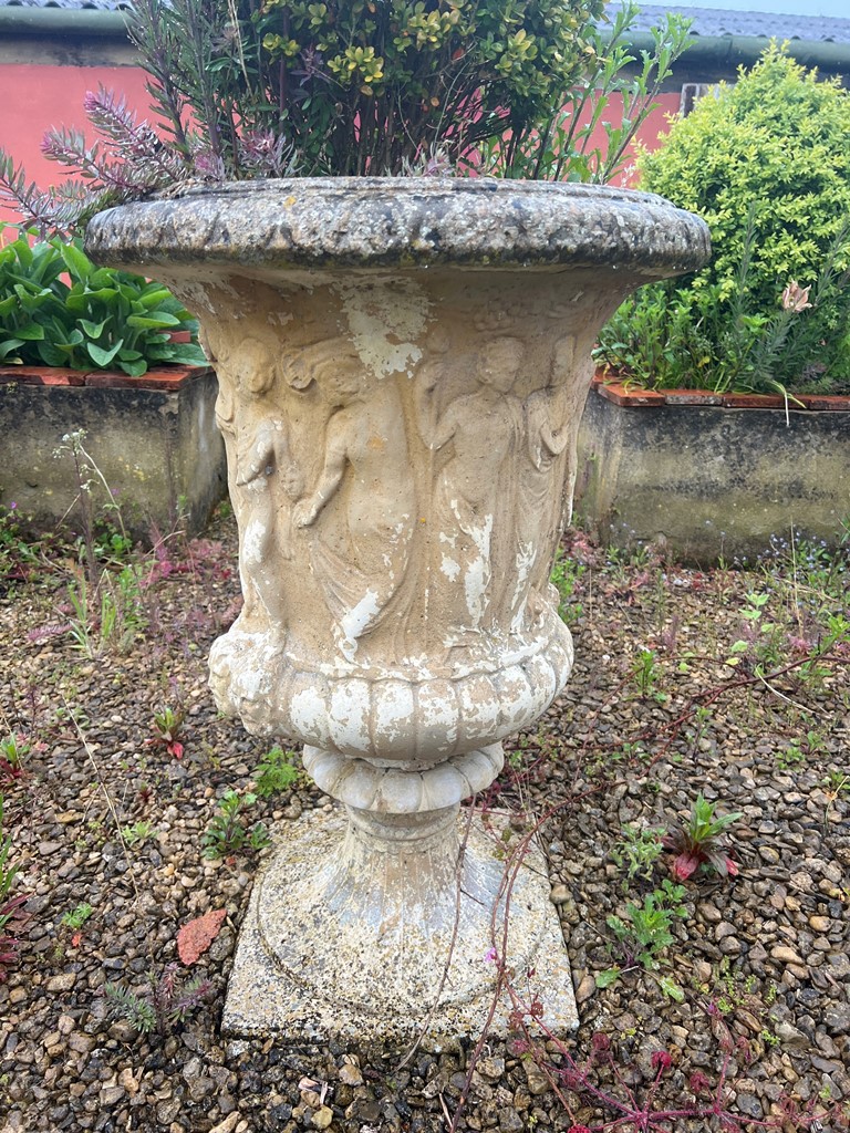 A composite stone garden urn - with figural and gadrooned decoration, on a pedestal base, 60cm