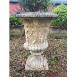 A composite stone garden urn - with figural and gadrooned decoration, on a pedestal base, 60cm
