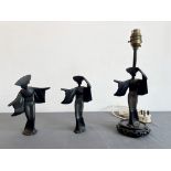 A set of three Oriental cast iron Art Deco style figures - depicting female dancers, with black