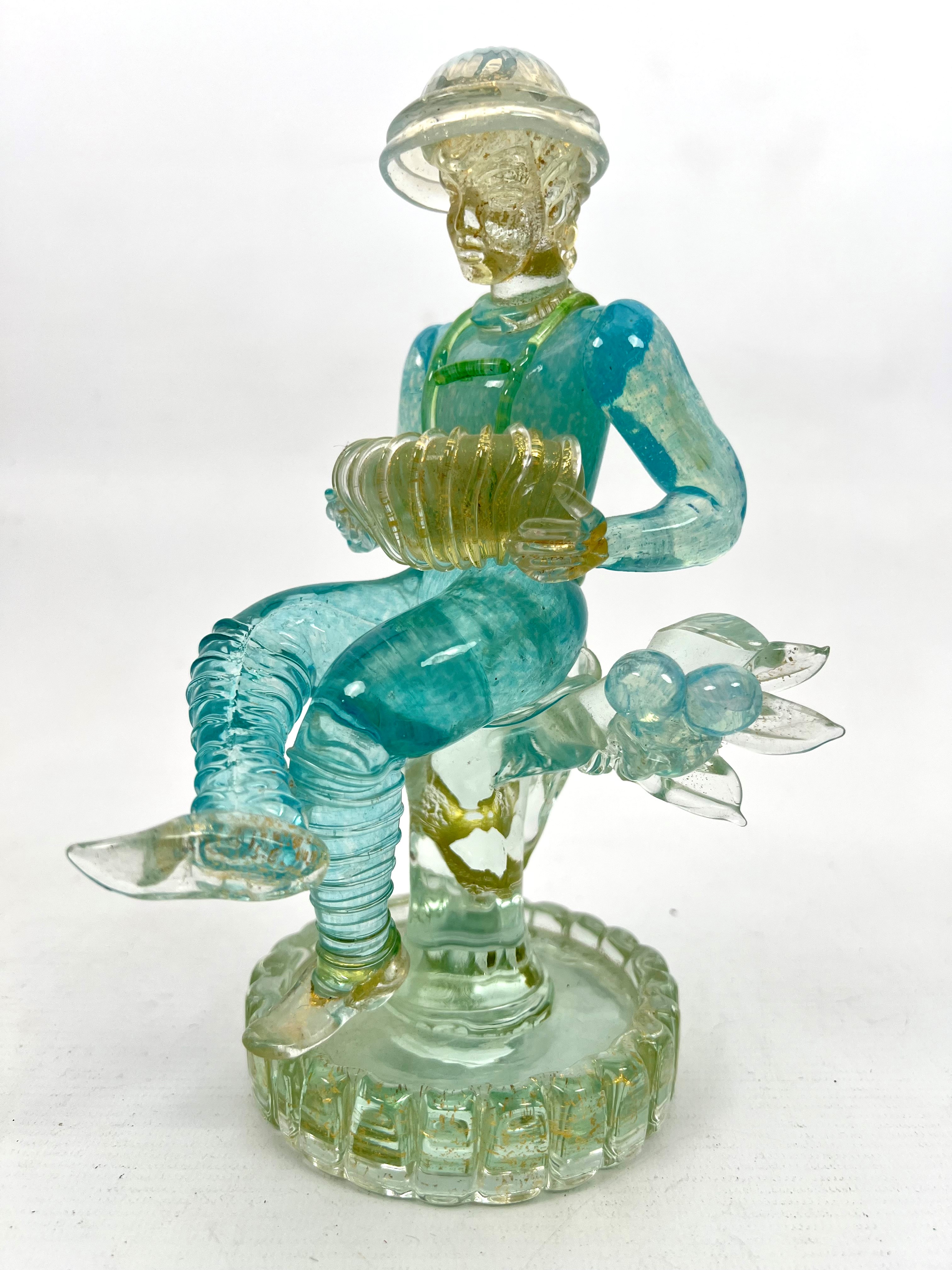 A Murano glass figure of a seated accordion player by Ercole Barovier for Ferro Barovier Toso - in