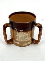 A miniature Doulton Lambeth salt glazed tyg - impressed factory marks and no. '9275', relief