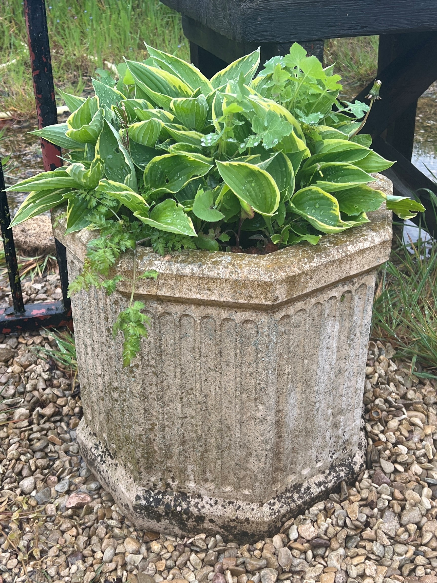 A hexagonal composite stone planter - 61cm high.