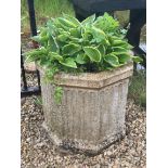 A hexagonal composite stone planter - 61cm high.