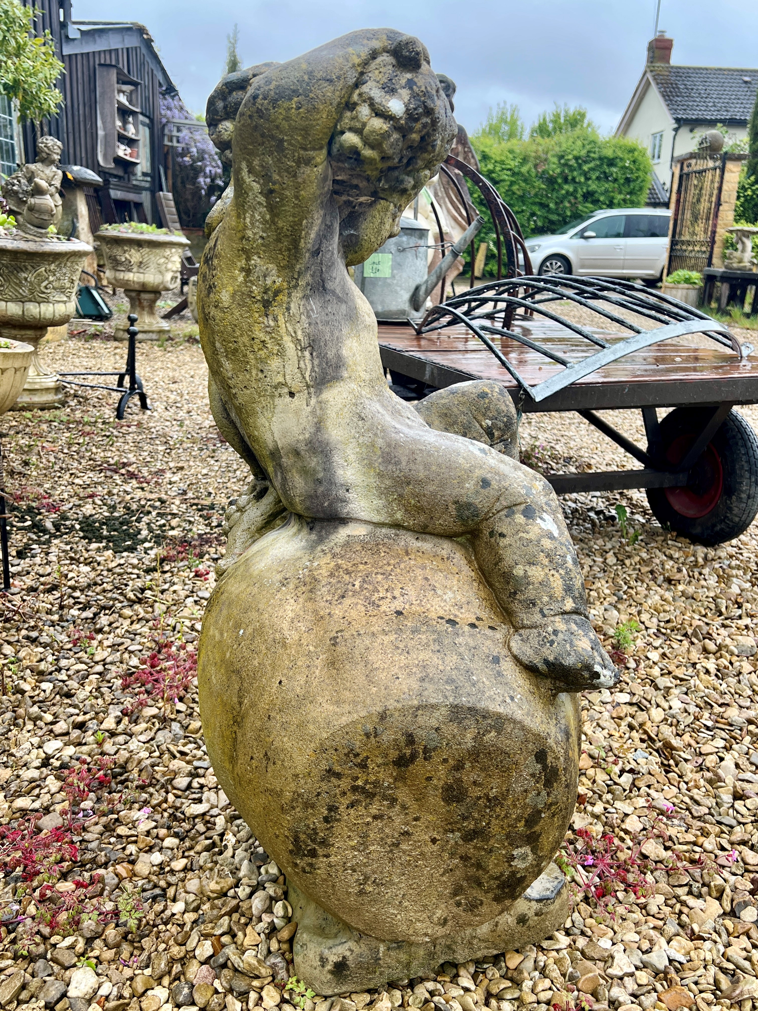 A composite stone statue of the young Bacchus sitting upon an upturned wine jar - 53 x 43cm x 90cm - Image 4 of 4