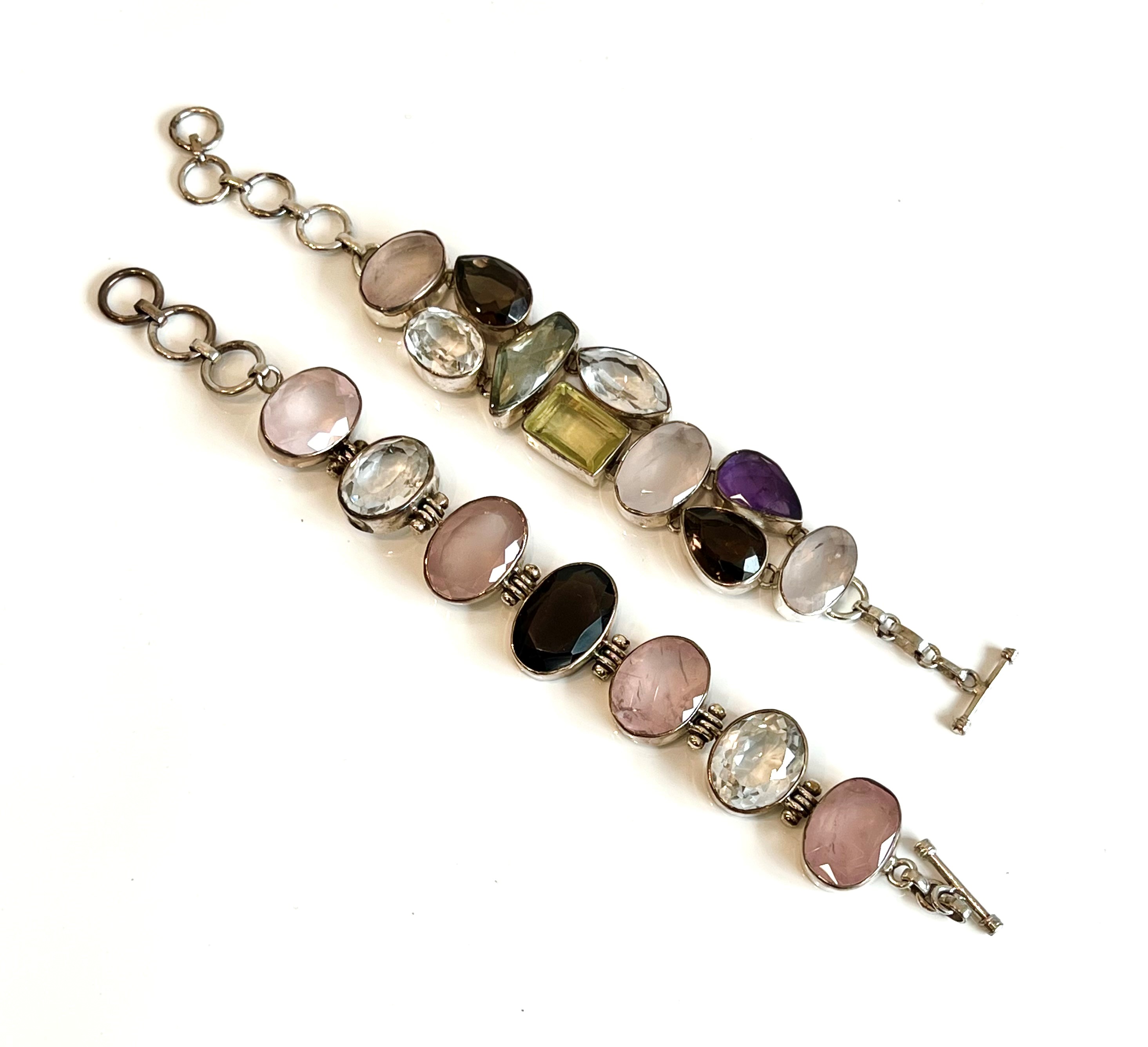 Two sterling silver and multigem bracelets - one with alternate oval cut rose quartz, rock crystal