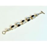 A sterling silver, moonstone and amethyst two-row bracelet - with central loop and bar clasp, set