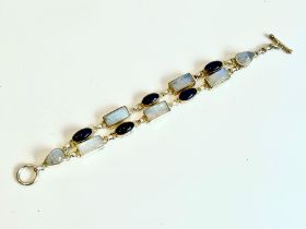 A sterling silver, moonstone and amethyst two-row bracelet - with central loop and bar clasp, set