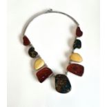 A silver and Baltic amber plaque necklace - with nine graduated asymmetric amber plaques, each rub-