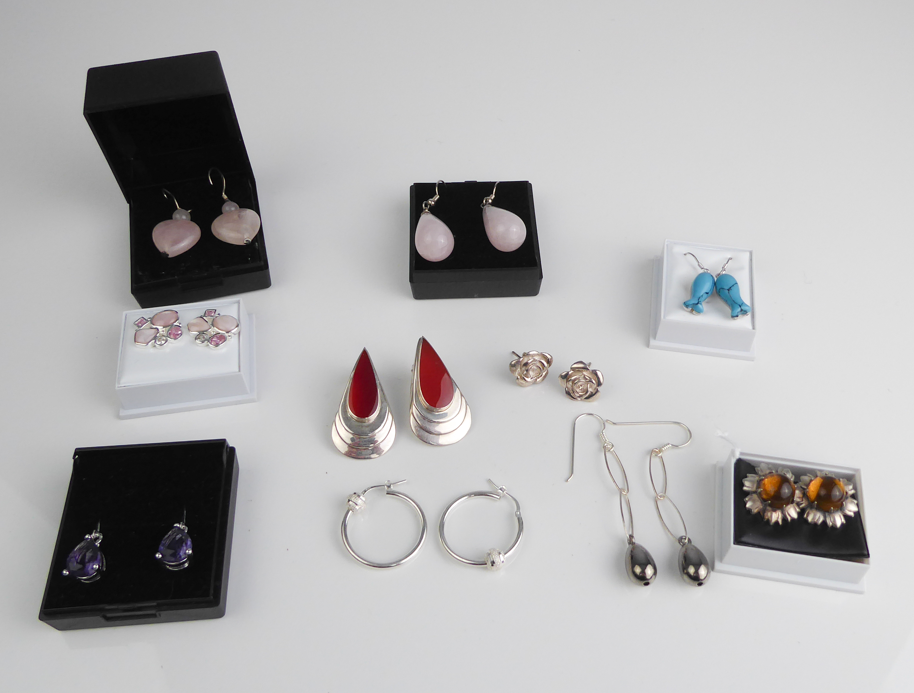 Nine pairs of silver earrings, most gemstone set