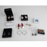 Nine pairs of silver earrings, most gemstone set