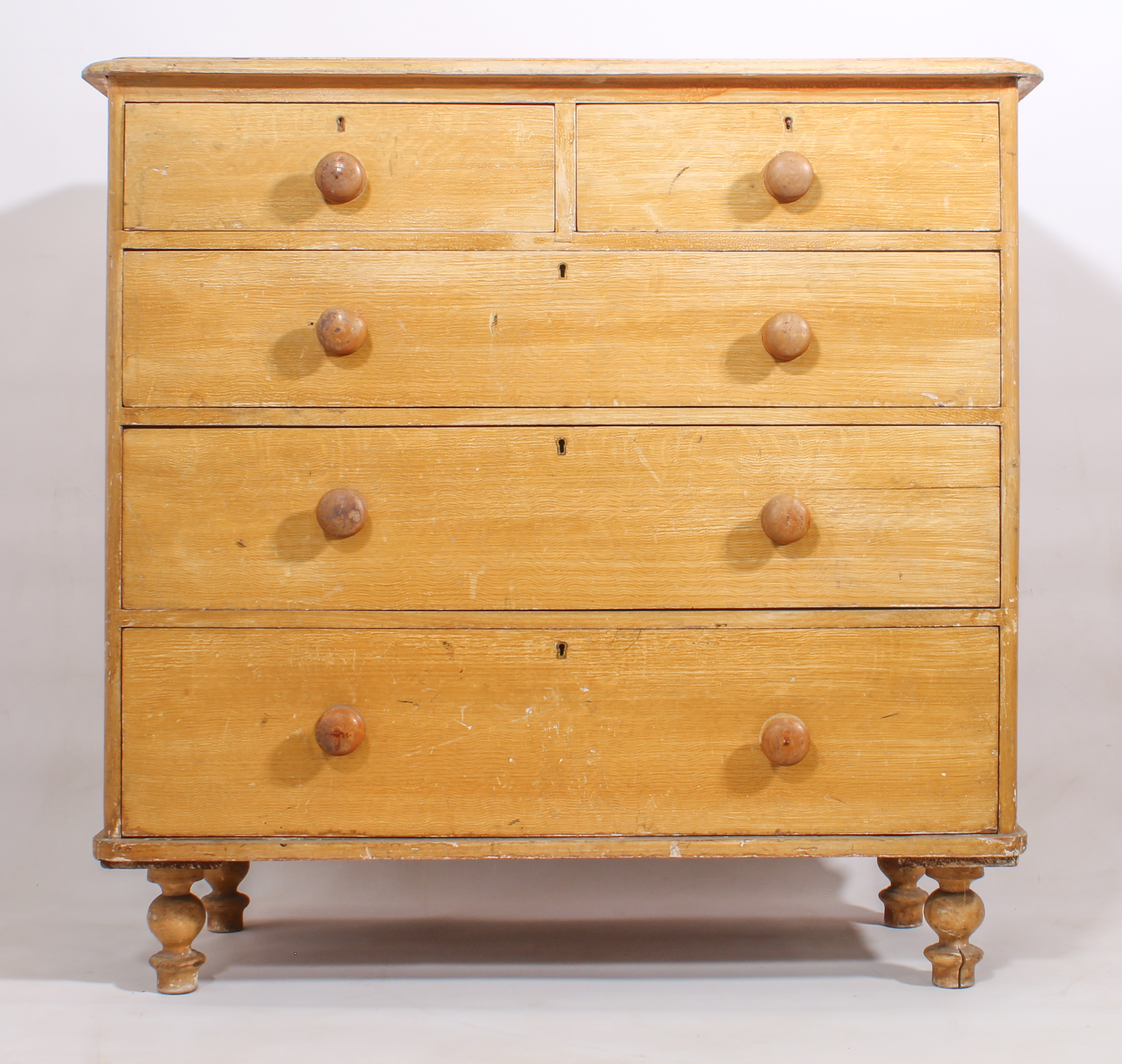 A Victorian scumble painted pine chest of drawers - the moulded top over two short and three long