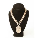 An early 20th century sterling silver necklace with silver-plated pendant locket - the pendant 50