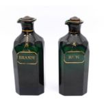 A pair of Georgian Bristol green glass and gilt spirit decanters - of square form with clipped