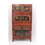 A Chinese red stained pine, lacquered and parcel-gilt three-piece compound cabinet - probably