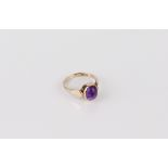 A 9ct gold and amethyst ring - hallmarked Sheffield 1996, the 9 x 7mm cabochon amethyst in a