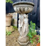 A composite stone bird bath - raised on a three graces style pedestal base, the bowl 46cm