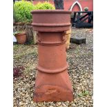 An antique terracotta chimney pot -  33 x 32cm at base, 75cm high, stamped 'T90' (crack to upper