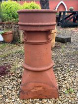 An antique terracotta chimney pot -  33 x 32cm at base, 75cm high, stamped 'T90' (crack to upper