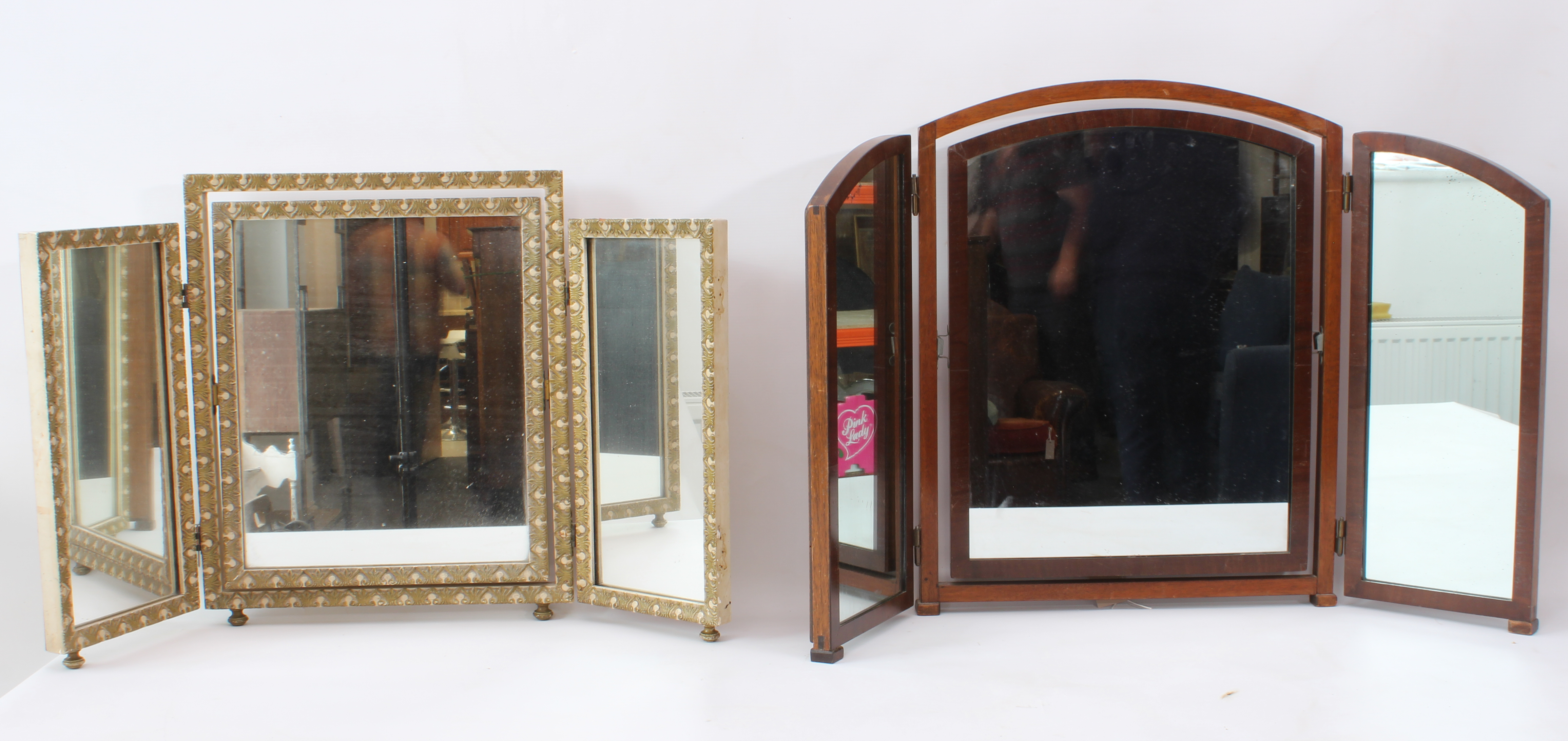 Two mid-century triple-fold dressing table mirrors - one mahogany, 57.5 cm high, 89.5 cm wide; the
