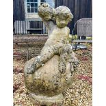 A composite stone statue of the young Bacchus sitting upon an upturned wine jar - 53 x 43cm x 90cm