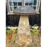 A Cotswold stone staddle stone - the top 39cm diameter x 13cm high, the base 50 x 36 x 94cm, 107cm