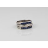 A platinum, sapphire and diamond three-row ring - unmarked, tested as platinum, the central row of