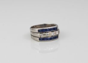 A platinum, sapphire and diamond three-row ring - unmarked, tested as platinum, the central row of