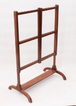 An Edwardian mahogany folding towel rail - with three rails and hinged sides, on arched supports